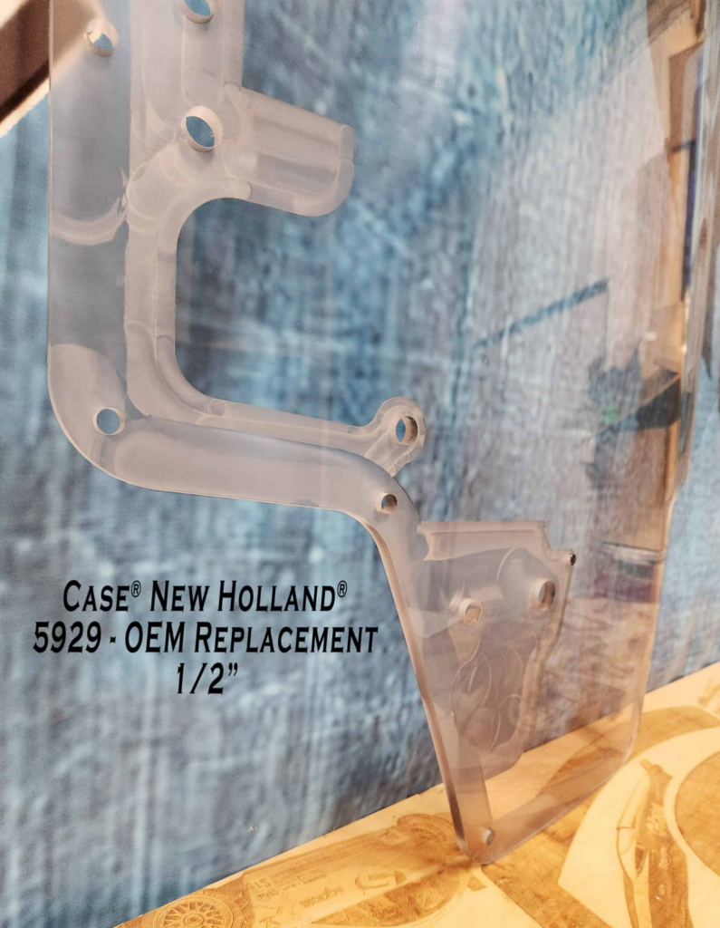 Close-up of the SHIELDS Case and New Holland dual-wiper OEM polycarbonate replacement windshield mounting area