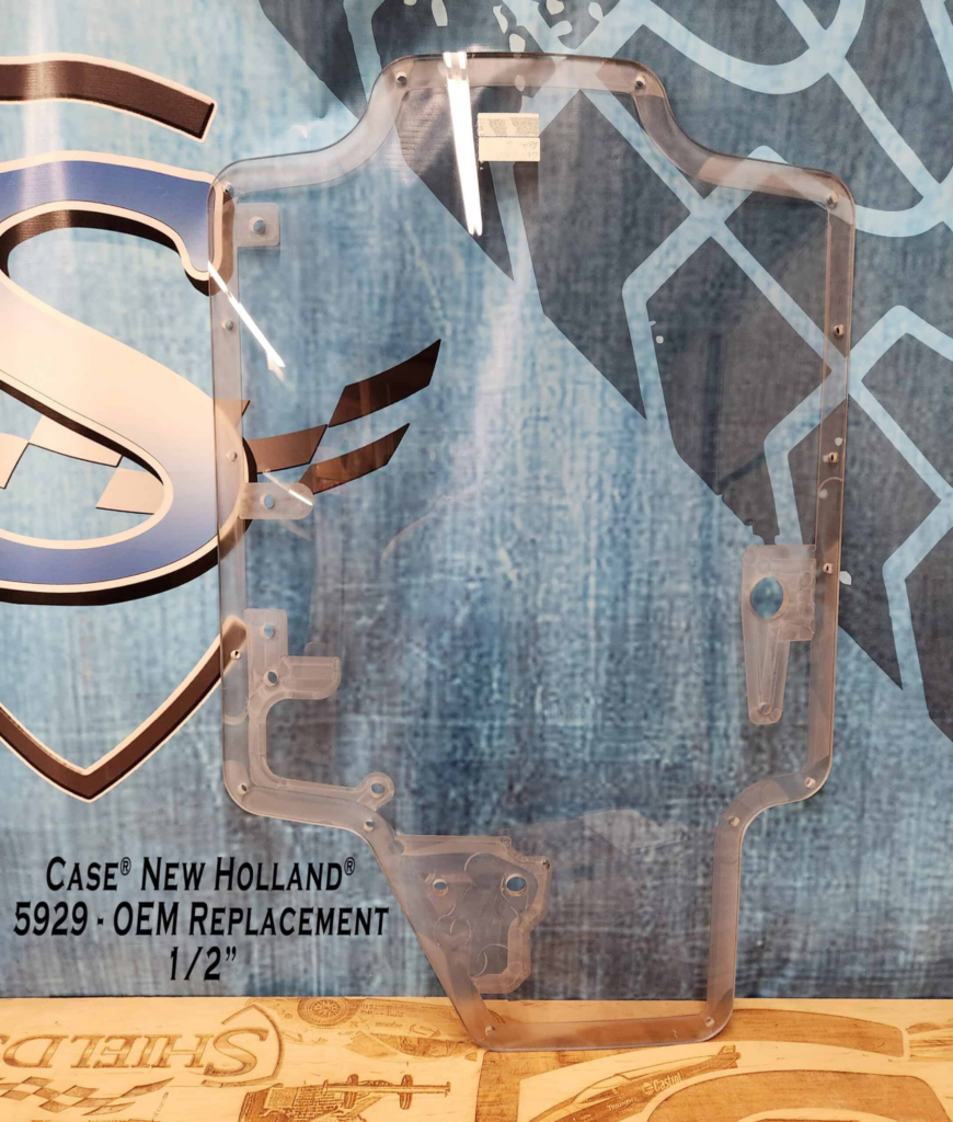 SHIELDS Case and New Holland dual-wiper OEM polycarbonate replacement windshield shown from the front