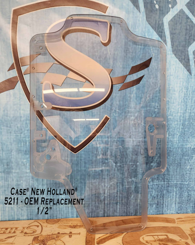 SHIELDS Case and New Holland single-wiper OEM polycarbonate replacement windshield shown from the front