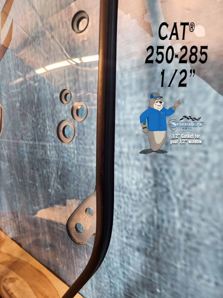 Close-up of the SHIELDS CAT 250-285 Series half-inch polycarbonate windshield showing the mounting holes and SHIELDS Seal
