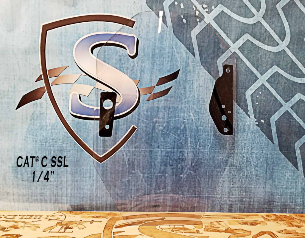 Front view of the SHIELDS CAT C Series quarter-inch polycarbonate skid steer windshield