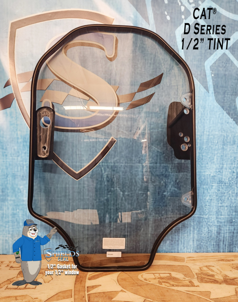 Front view of the SHIELDS CAT D Series half-inch tinted polycarbonate skid steer windshield with SHIELDS Seal