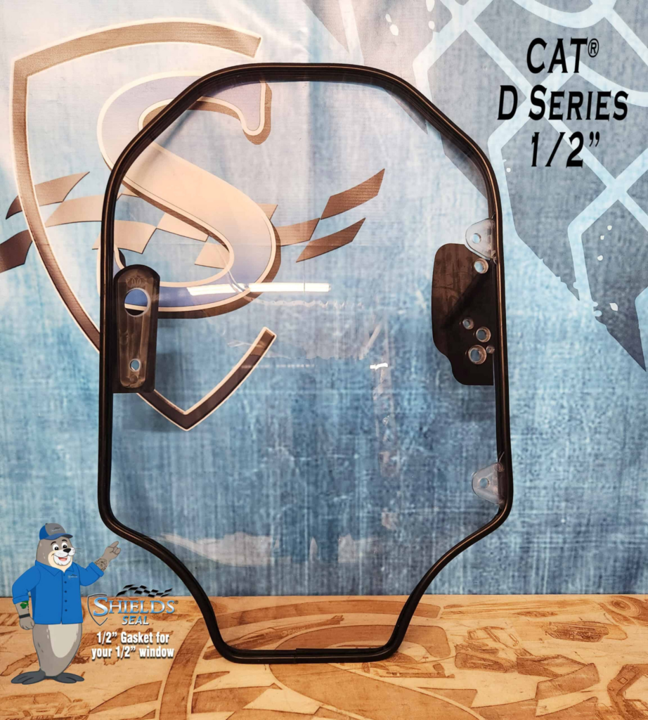 Front view of the SHIELDS CAT D Series half-inch clear polycarbonate skid steer windshield with SHIELDS Seal