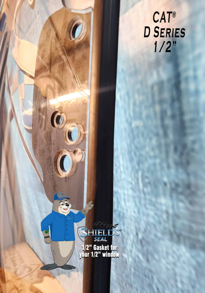 Close-up of the SHIELDS CAT D Series half-inch polycarbonate windshield showing the right-side mounting holes and SHIELDS Seal