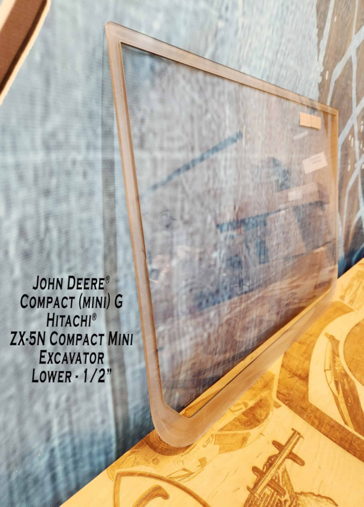 Angled side view of SHIELDS John Deere Compact G & P Series polycarbonate lower excavator windshield.