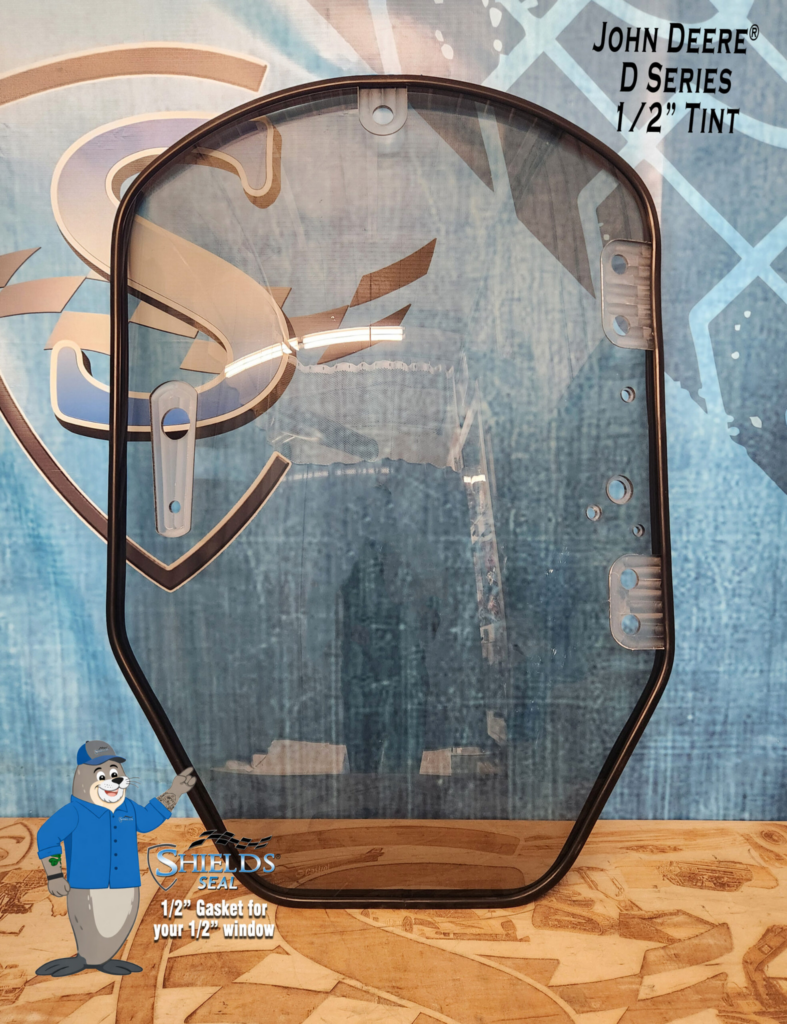 Front view of the SHIELDS John Deere D and E Series half-inch tinted polycarbonate skid steer windshield with SHIELDS Seal