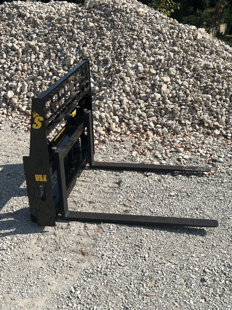 Side view of the Stinger Attachments CPF Mini Skid Steer Compact Pallet Fork showing the fork profile and compact frame
