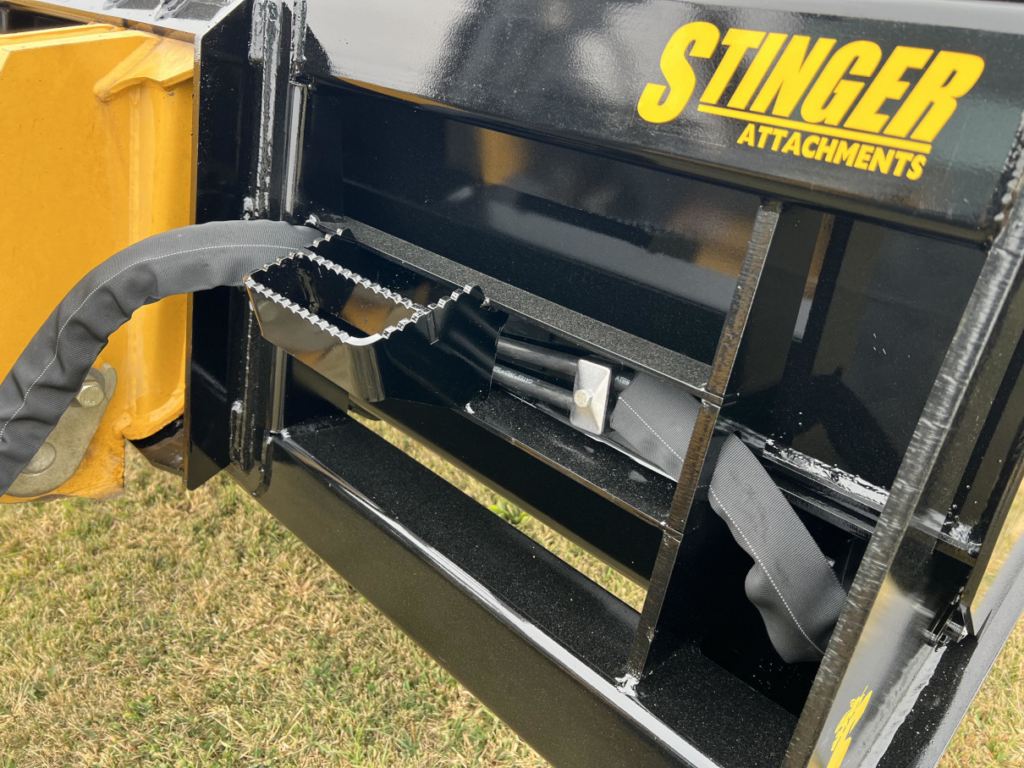 Close-up of the Stinger HDB Wheel Loader Hydraulic Dump Bucket showing the safety step, hydraulic components, and mount frame