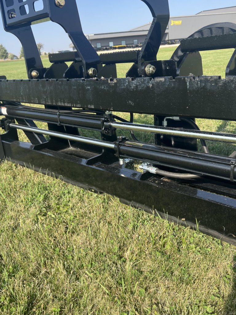 Close-up of Stinger PF3H hydraulic pallet fork cylinders and synchronized fork positioning system