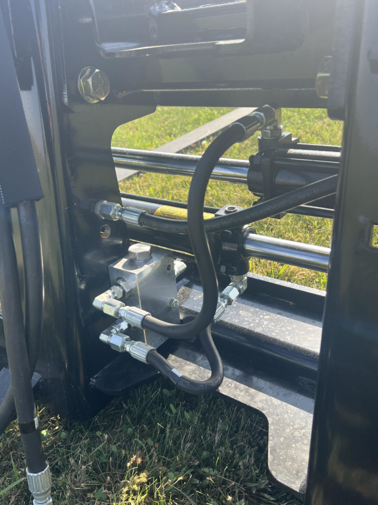 Close-up of Stinger PF3H hydraulic hoses, valve block and fork positioning cylinder