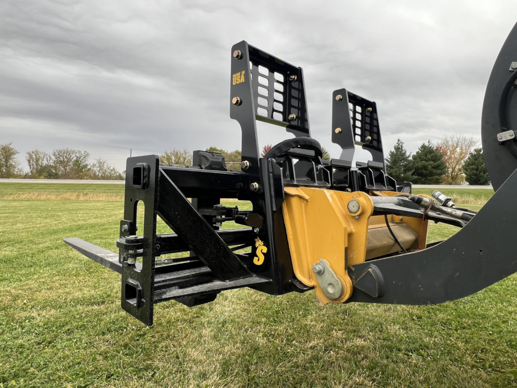 Rear detail of Stinger PF3H hydraulic pallet forks mounted to a wheel loader with hydraulic lines
