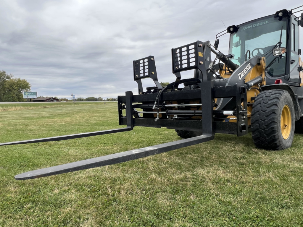 Stinger PF3H hydraulic pallet forks mounted on a John Deere wheel loader with long tines extended