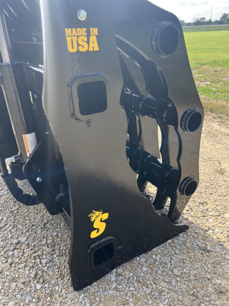 Close-up side view of the Stinger Severe Duty Wheel Loader Clam Grapple showing the reinforced side frame, pivot points, and Made in USA marking