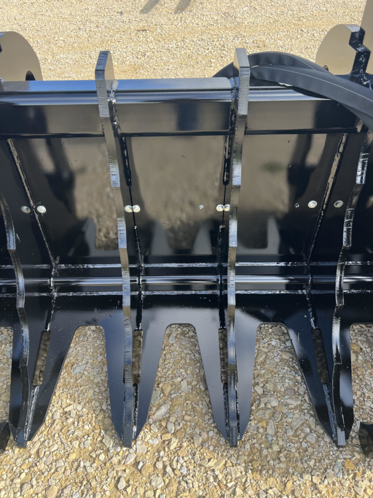 Close-up of the Stinger Severe Duty Wheel Loader Clam Grapple showing the heavy steel tines, tine spacing, and reinforced back structure