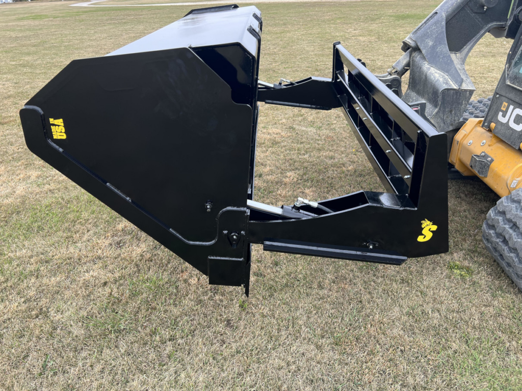 Side view of the Stinger skid steer hydraulic dump bucket raised in the dumping position