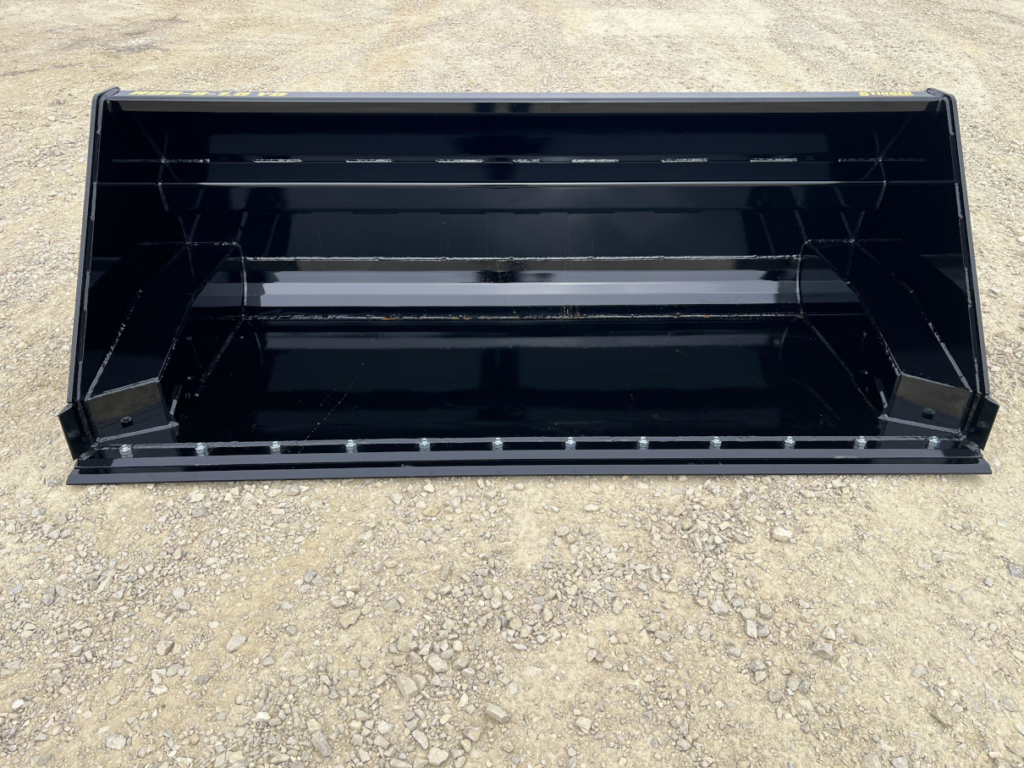 Front interior view of the Stinger skid steer hydraulic dump bucket showing the reinforced shell and bolt-on cutting edge