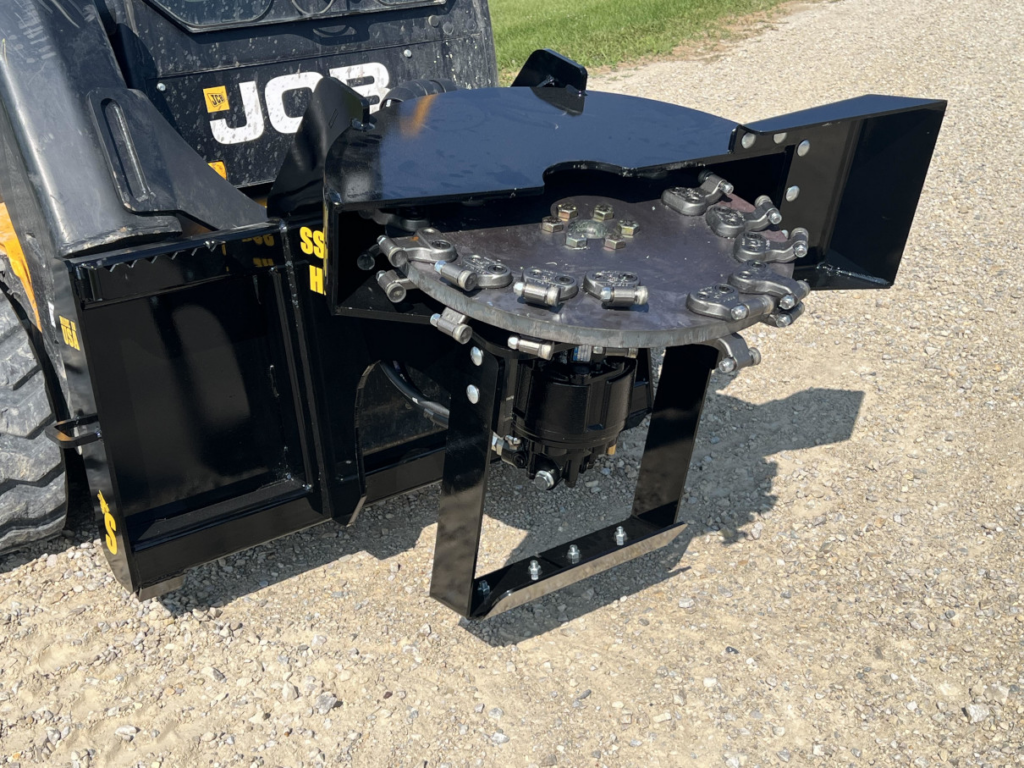 Angled view of the Stinger skid steer stump grinder cutting wheel, carbide teeth, motor, and frame
