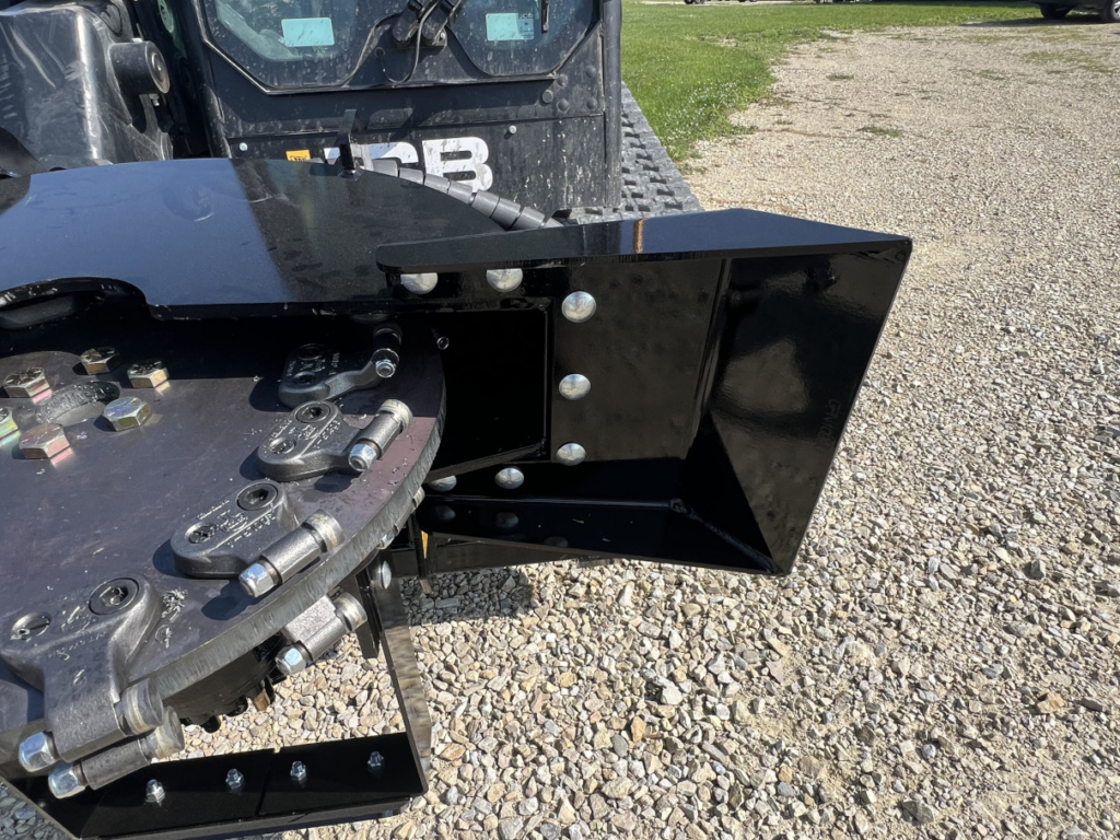 Close-up of the Stinger skid steer stump grinder cutting wheel, carbide teeth, and scooped deflector