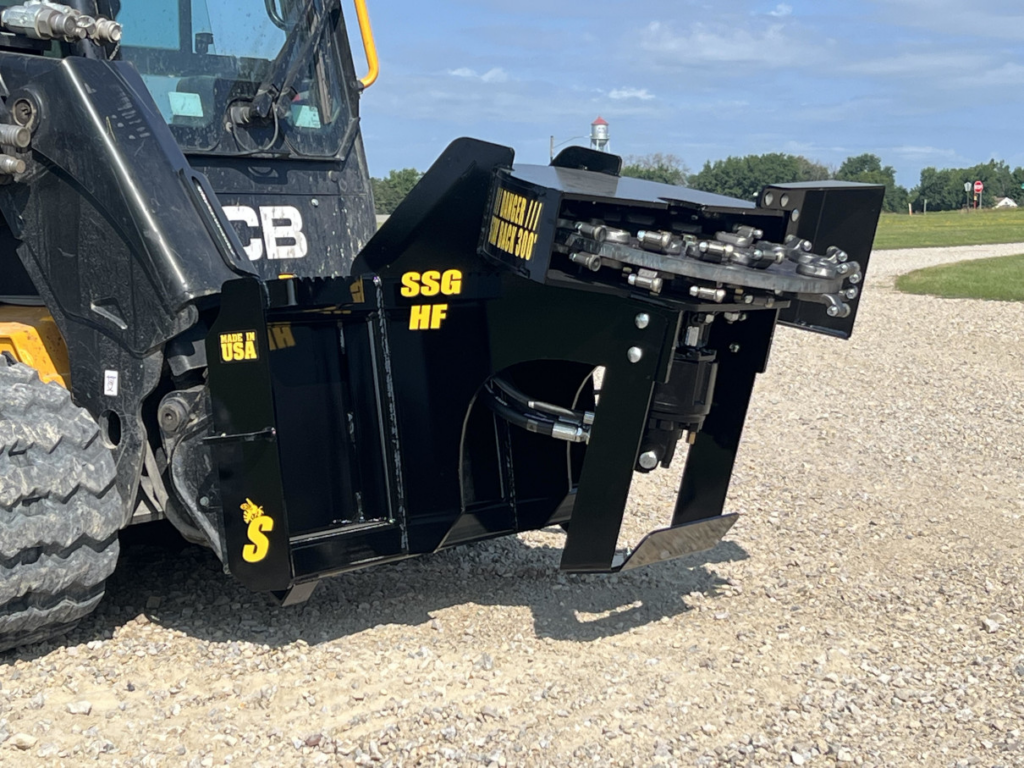 Left side view of the Stinger skid steer stump grinder mounted on a compact track loader