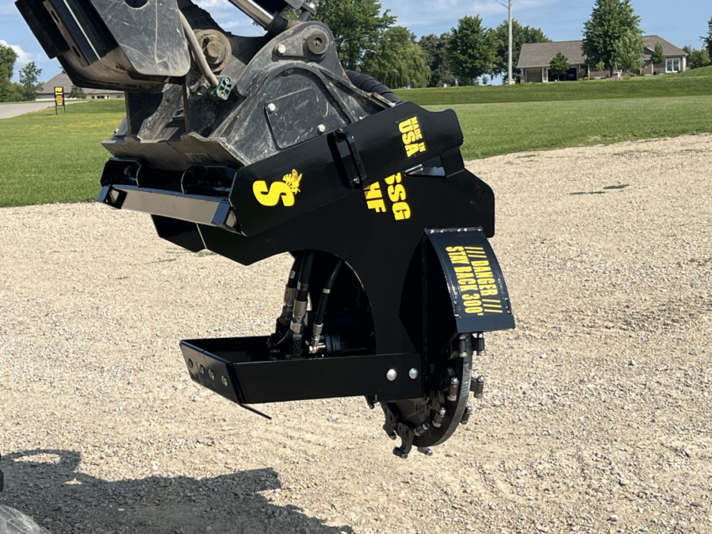 Rear angled view of the Stinger skid steer stump grinder mounted on a compact track loader