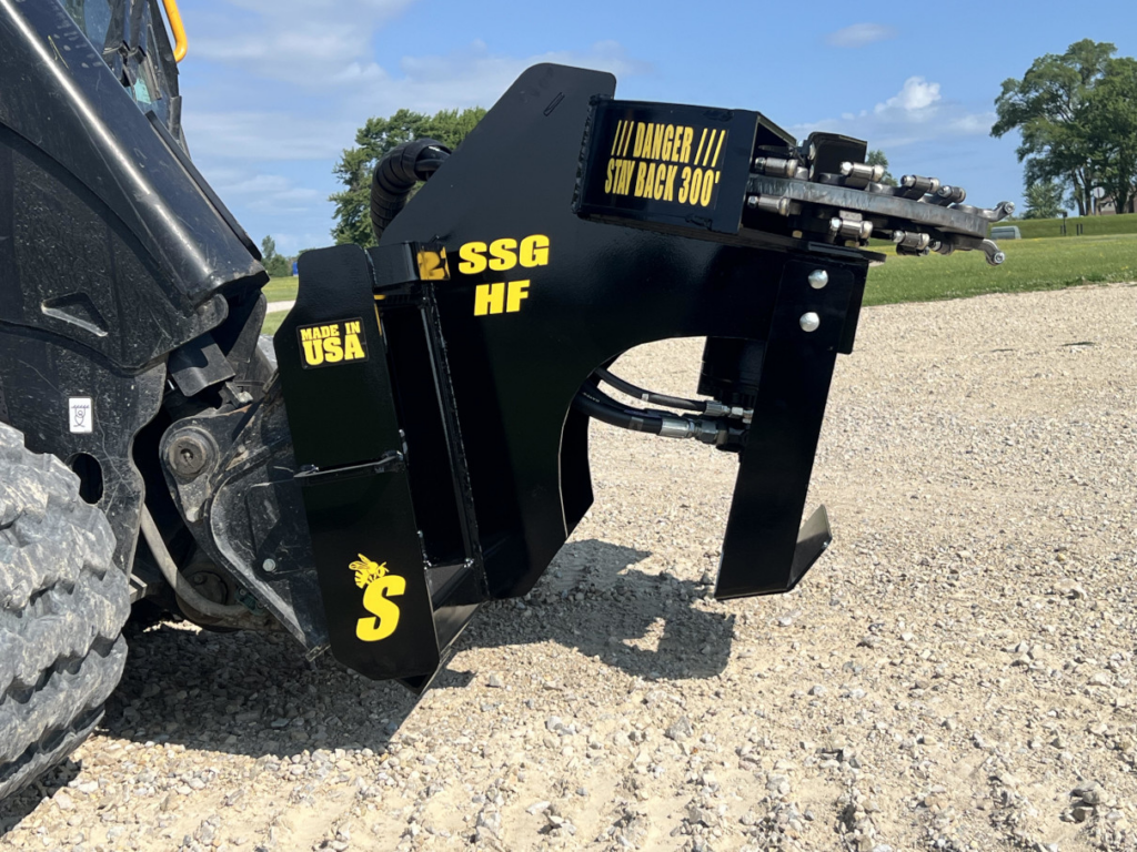 Right side view of the Stinger skid steer stump grinder mounted on a compact track loader