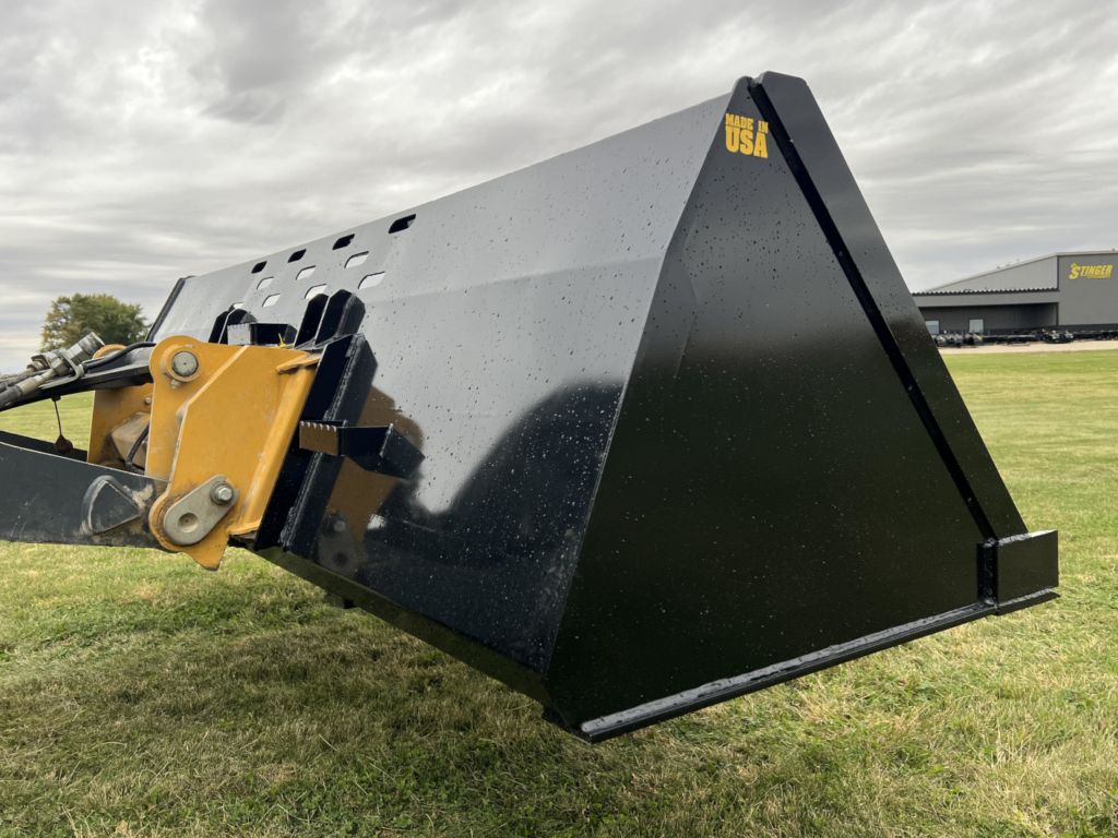 Side view of the Stinger SNB Wheel Loader Snow Bucket mounted on a John Deere wheel loader