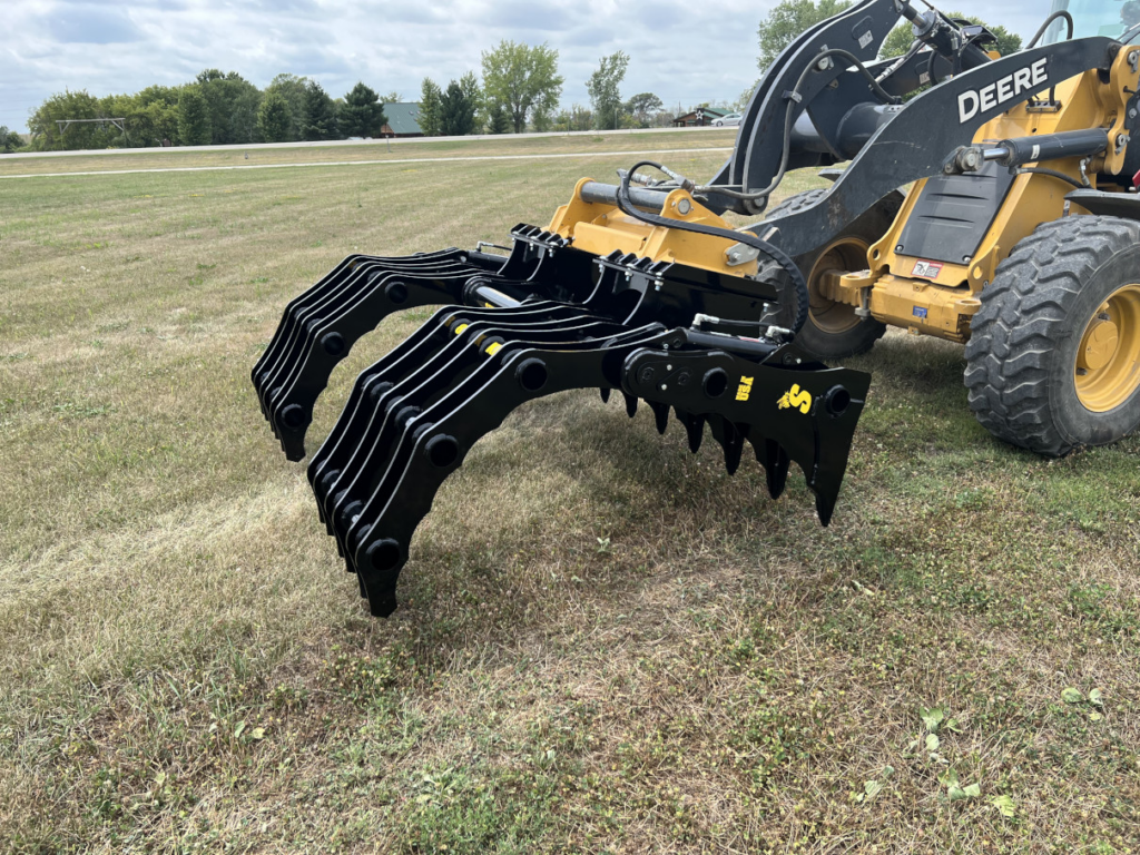 Side angled view of the Stinger Wheel Loader Clam Grapple opened wide on a John Deere wheel loader