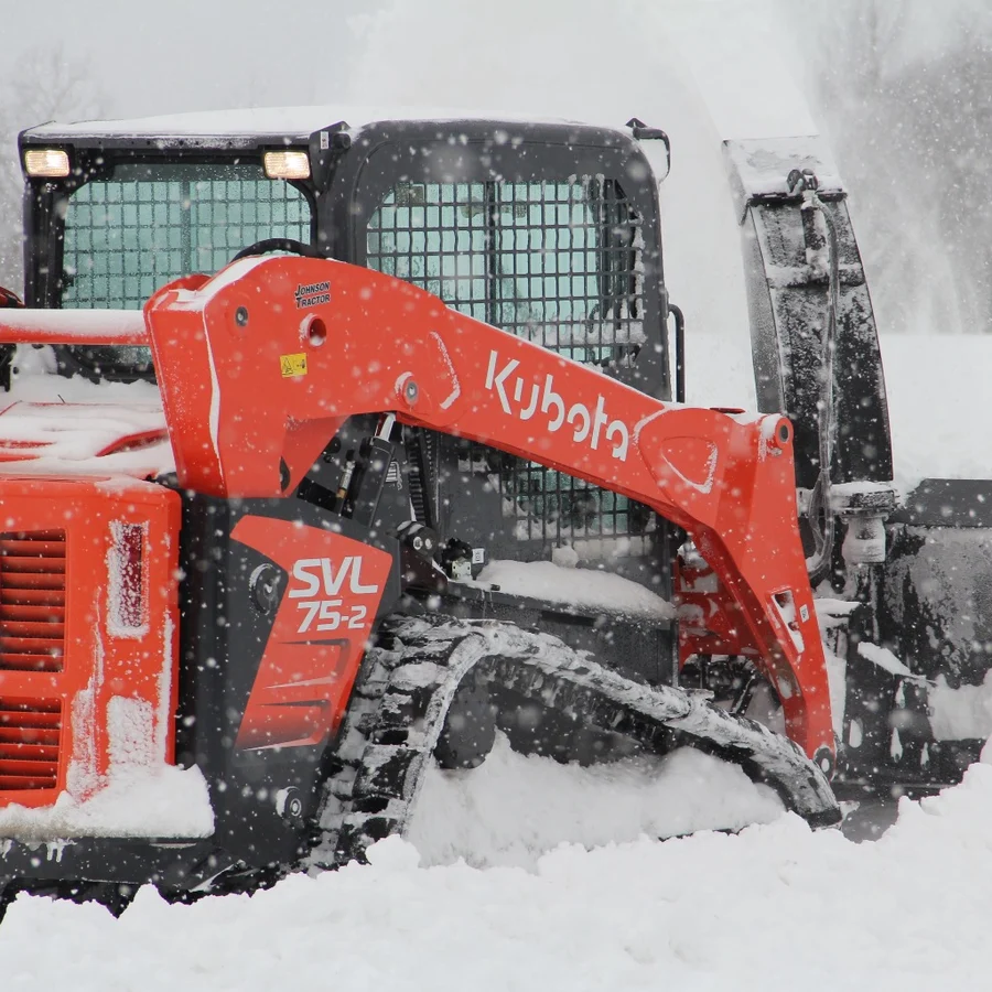 Stout TrackClaws installed on a Kubota SVL75-2 compact track loader working in snow