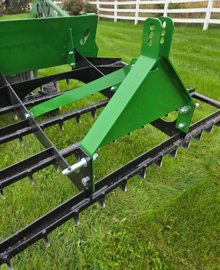 Close view of the SWAT Metal Works 72" Compact Land Rake 3-point hitch and top-link connection for compact tractors.