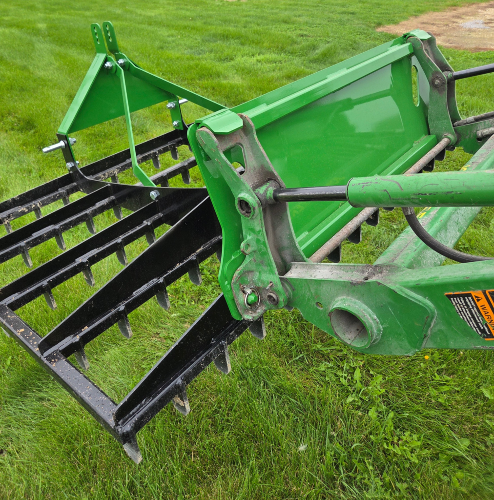 Close view of the SWAT Metal Works 72" Compact Land Rake skid steer quick-attach mounting area.