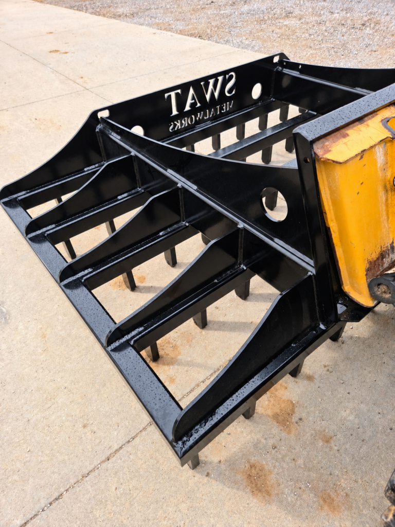 Rear angled view of the SWAT Metal Works Skid Steer Land Rake showing the open frame and scarifier layout
