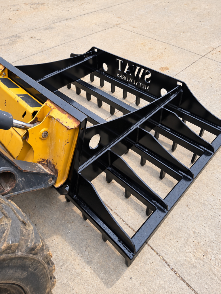Top angled view of the SWAT Metal Works Skid Steer Land Rake showing the welded frame and grading rails