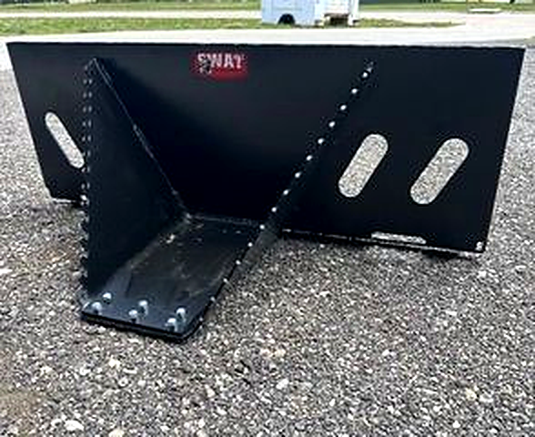 Front view of the black SWAT Metal Works Mini Stump Buster showing the pointed snout, replaceable cutting edge, and serrated side edges.