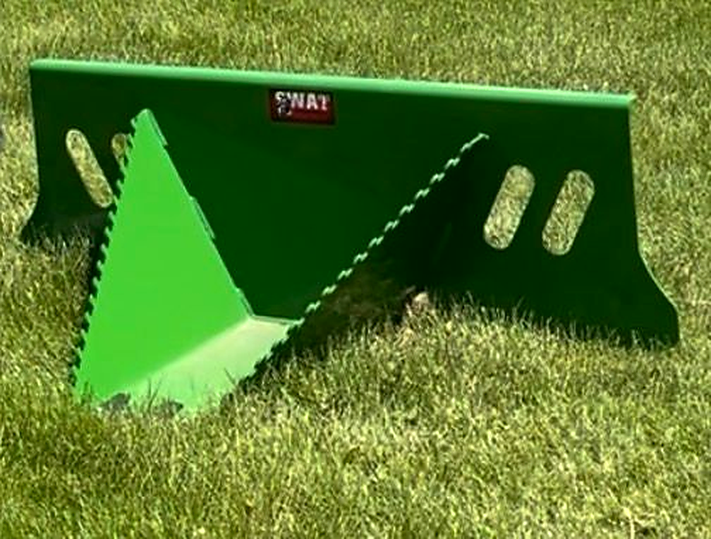 SWAT Metal Works Mini Stump Buster in John Deere Green showing the pointed snout, serrated side edges, and quick-attach mounting plate.